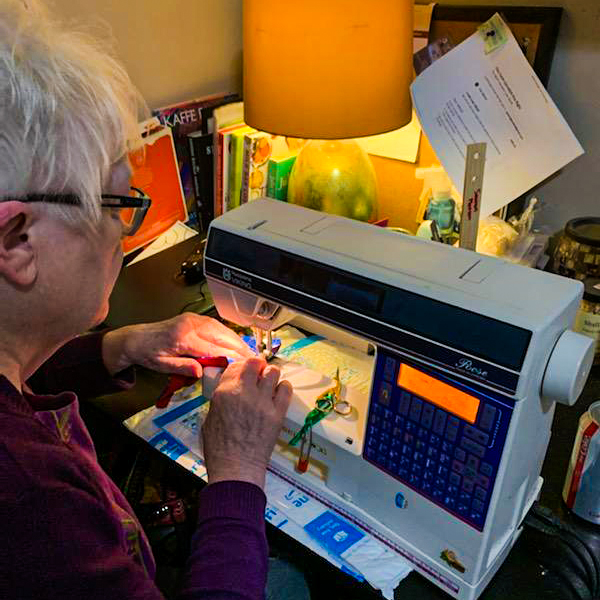 Wisconsin woman, Jeanne Gosselin, sewing masks at home